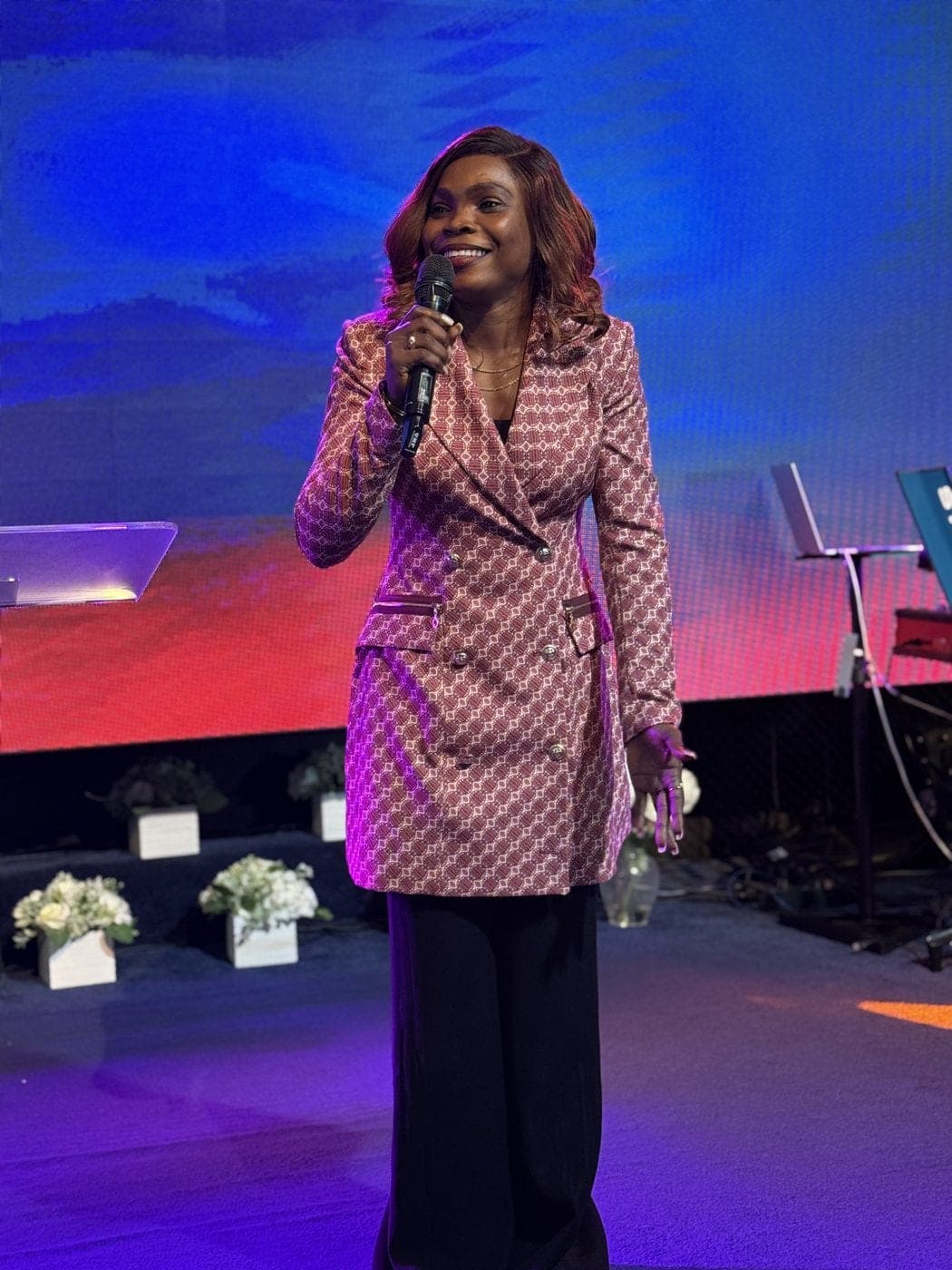 A worship leader singing on stage